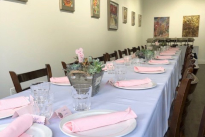 Long table room with paintings on the walls